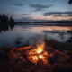 A campfire on the shore of a lake.