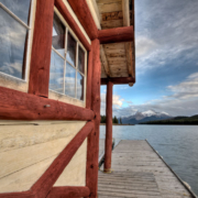 A lake home with a dock looking out at the lake.