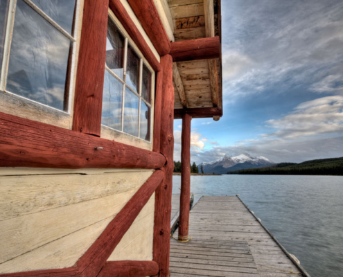 A lake home with a dock looking out at the lake.