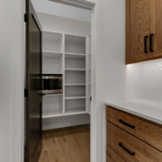 A walk-in pantry closet providing storage space in a family home.