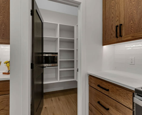 A walk-in pantry closet providing storage space in a family home.