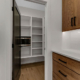 A walk-in pantry closet providing storage space in a family home.