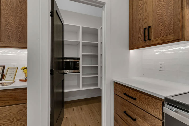 A walk-in pantry closet providing storage space in a family home.
