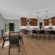 An open-concept kitchen, dining room, and living room space on the main floor of a family home.