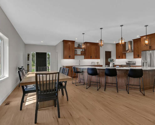 An open-concept kitchen, dining room, and living room space on the main floor of a family home.