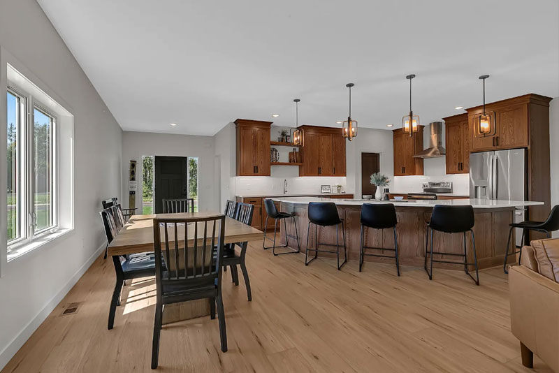 An open-concept kitchen, dining room, and living room space on the main floor of a family home.