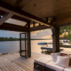 A covered deck outside a custom lake home.