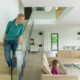 A woman walking down the stairs to her daughter in a two-story home.